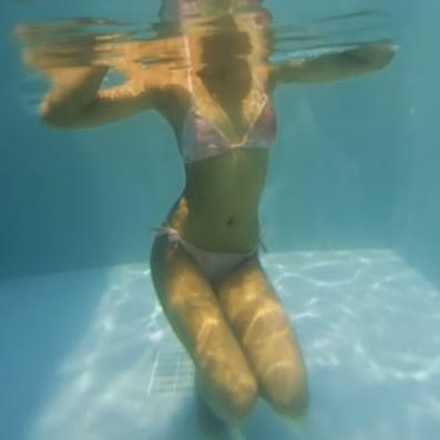 Two Asian girls in bikini having fun underwater